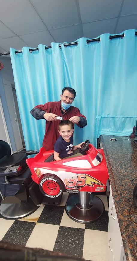 A young customer getting a haircut at Royal Barber Shop